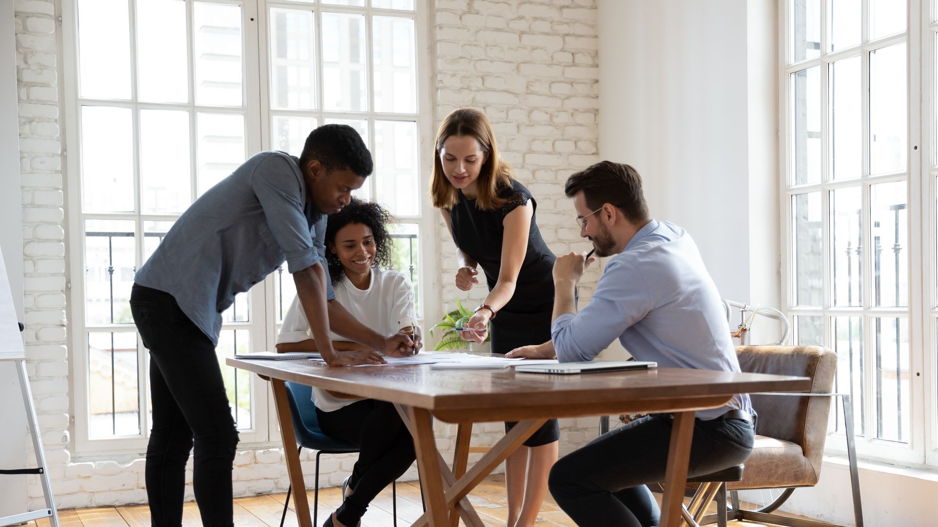 A team of young, diverse decision makers work together to create a comprehensive employee benefits strategy for their company