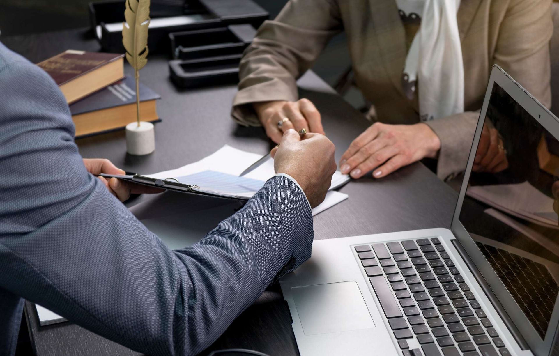 Young couple looking at tablet talking with a general liability insurance advisor