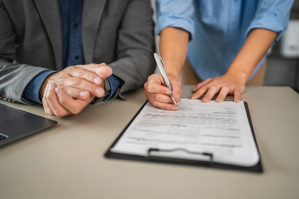 close up female hand hold pencil and sign contract near male colleague in the office