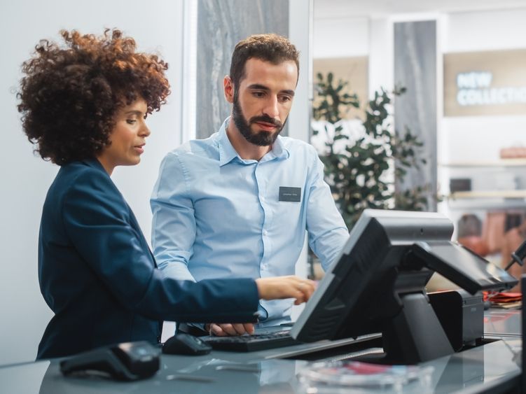 Young couple looking at tablet talking with a general liability insurance advisor