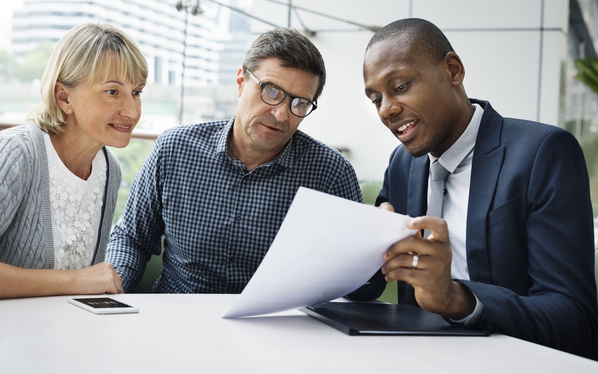 A black insurance agent describing the differences between ocip vs ccip to two business owners