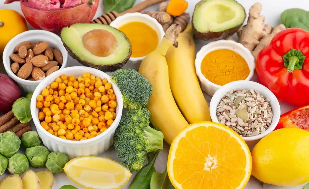 There are many different types of fruits and vegetables on the table.