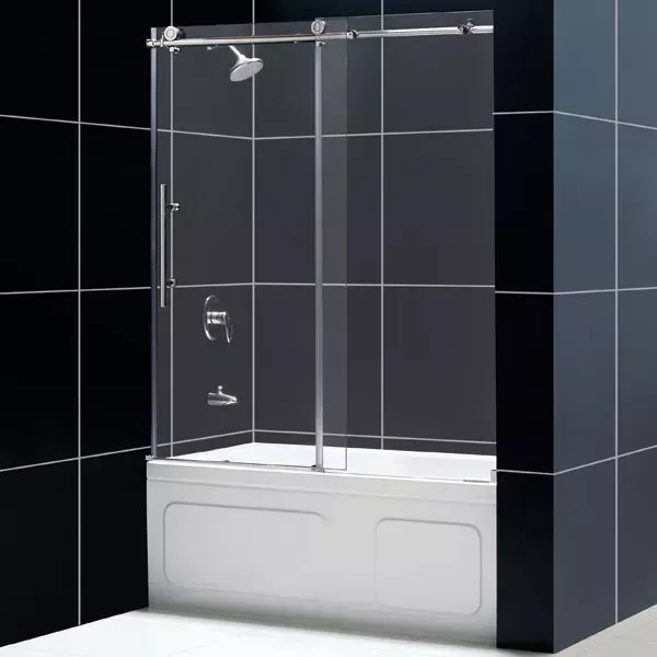 Modern bathroom with a glass shower enclosure over a white tub against black tiled walls