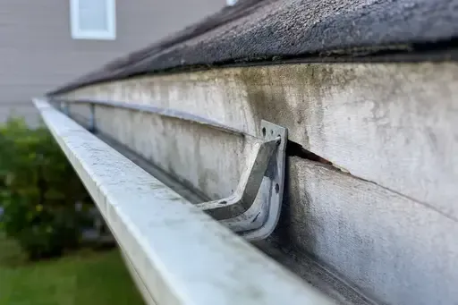 Gutter hanger pulling away from fascia board on a Wichita home showing signs of incorrect gutter installation