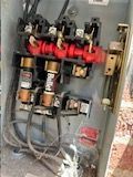 A close up of an electrical box with a lot of wires coming out of it.