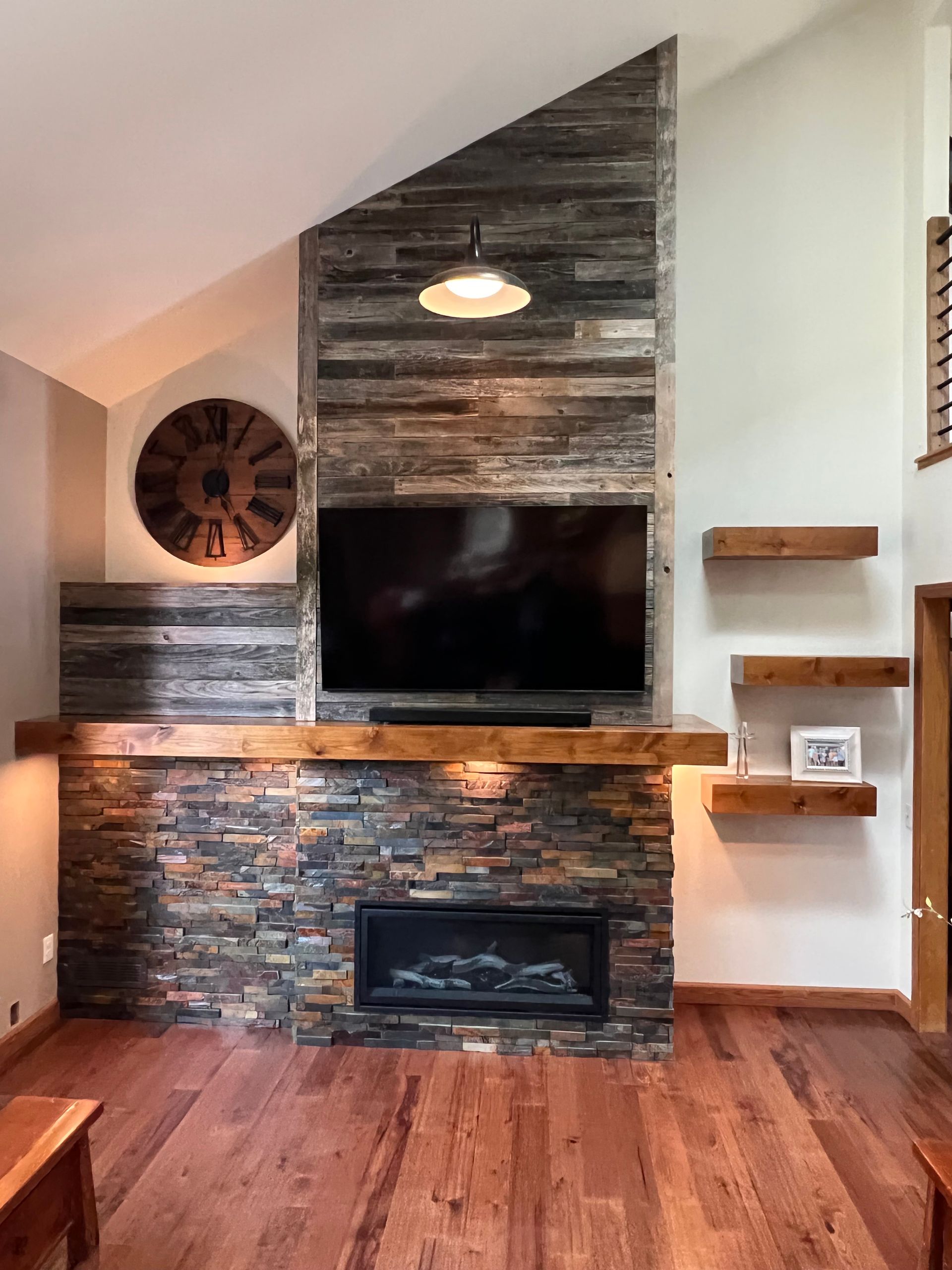 A living room with a fireplace and a flat screen tv.