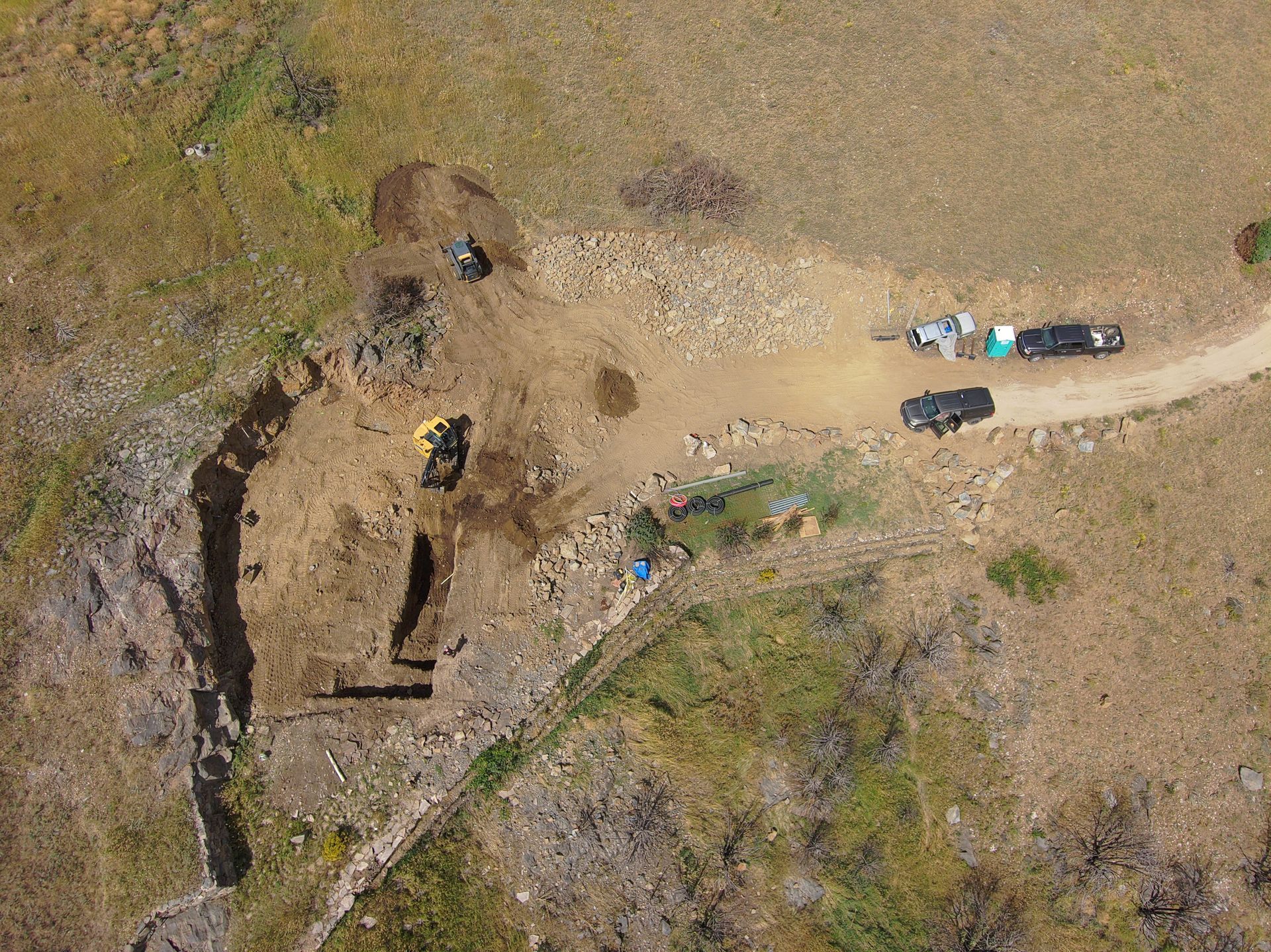 An aerial view of a dirt road in the middle of a field.