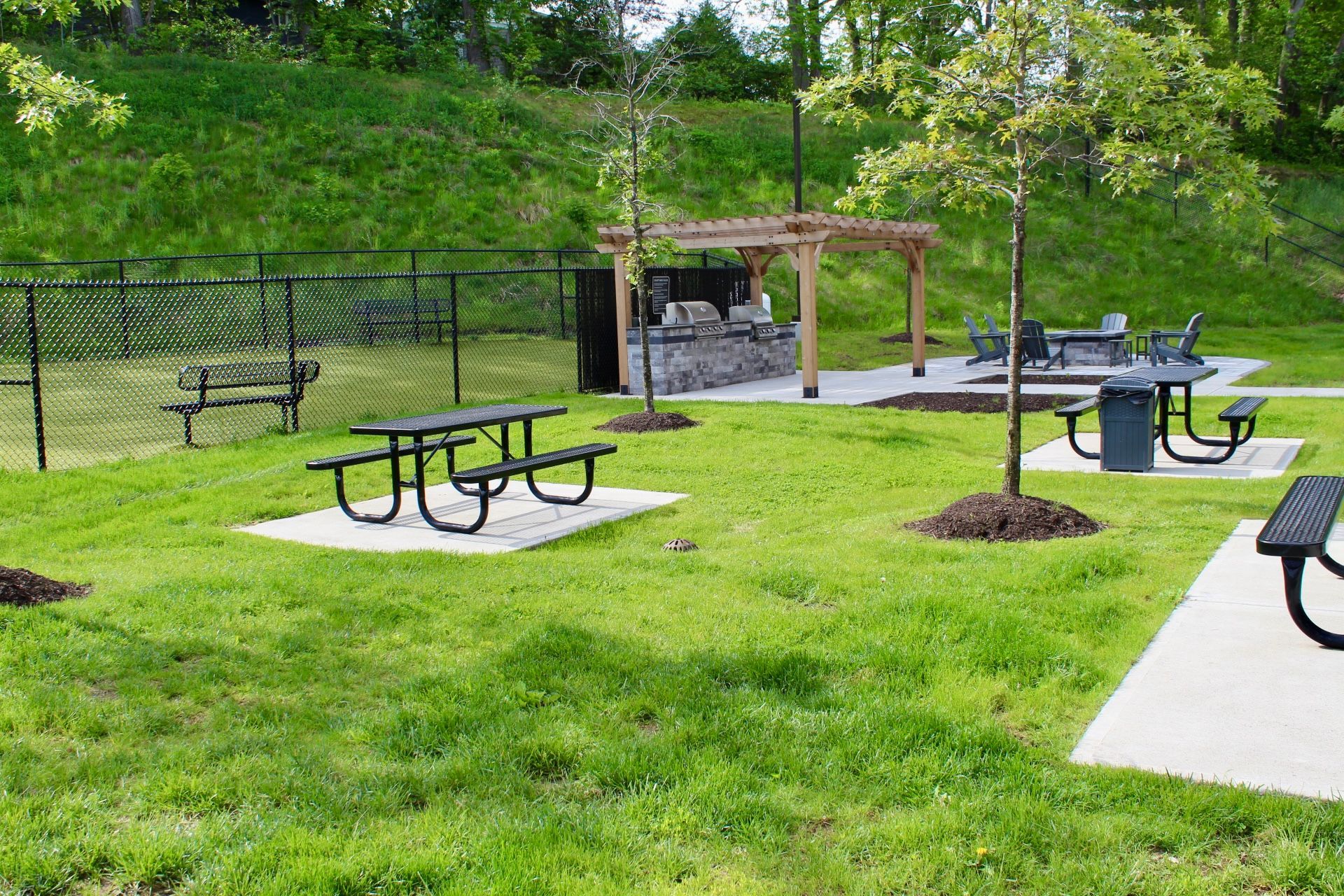The landscaped outdoor grounds and green space at The Kiln, a pet-friendly apartment community in Worcester, MA