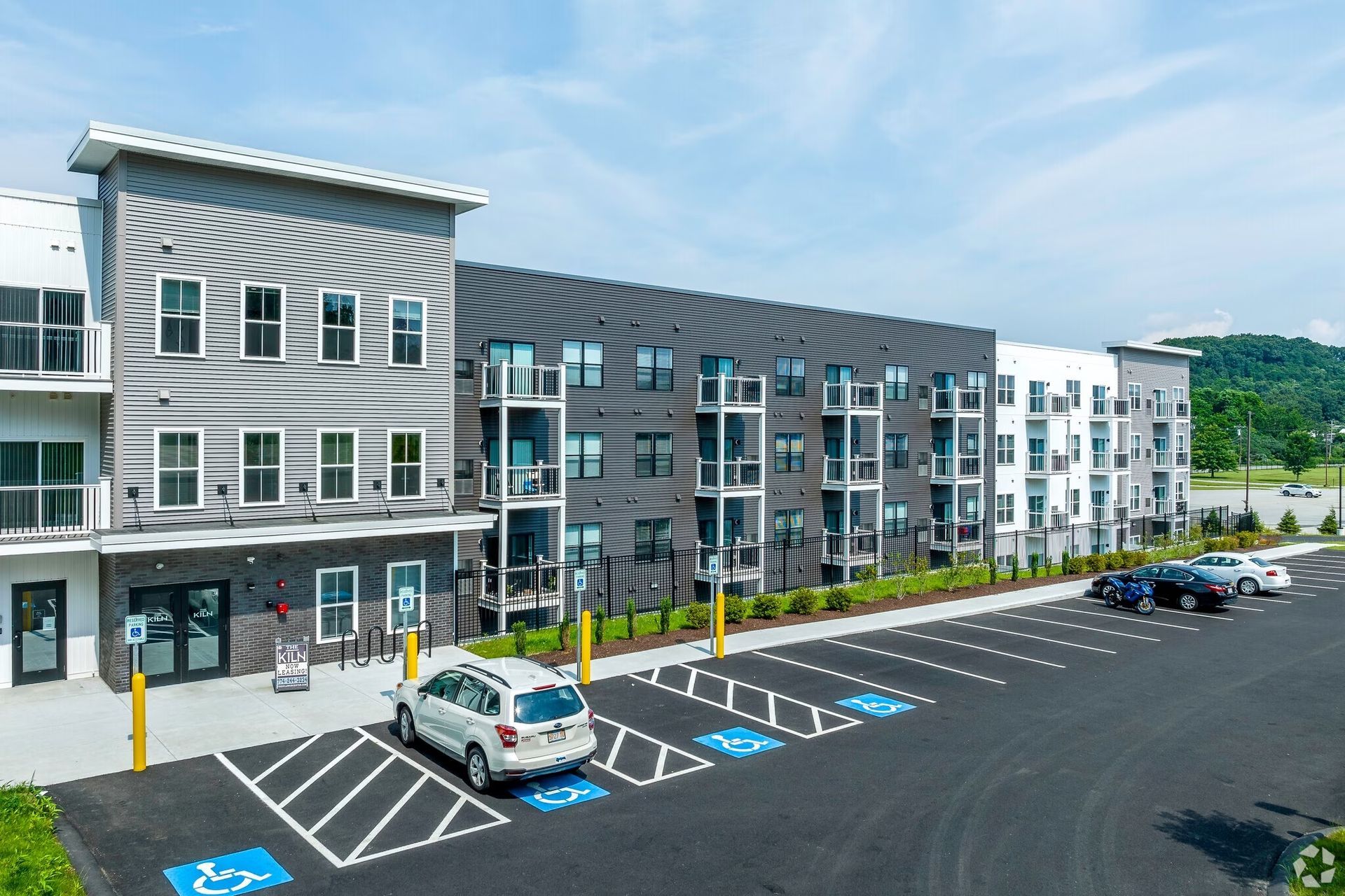 a large apartment building with a parking lot in front of it