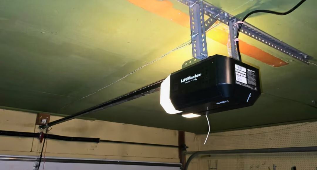 Ceiling-mounted black projector with a bright beam in a green tent-like room