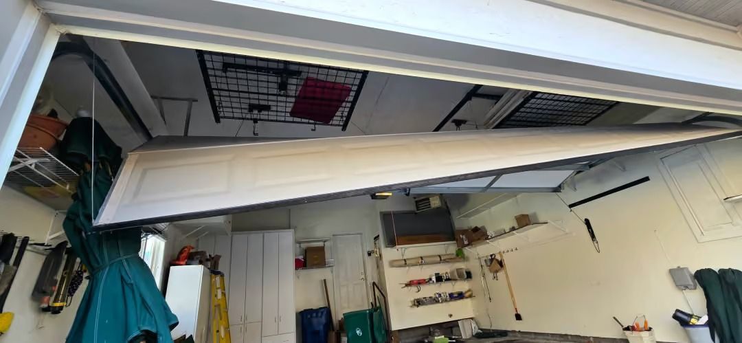 Tilted view of a cluttered storage room with shelves, tools, and hanging items