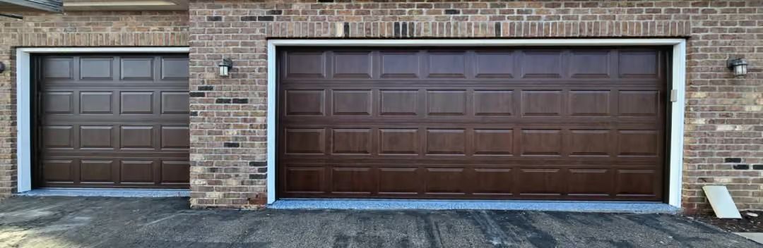 Brick house facade with two dark brown garage doors, one single and one double.