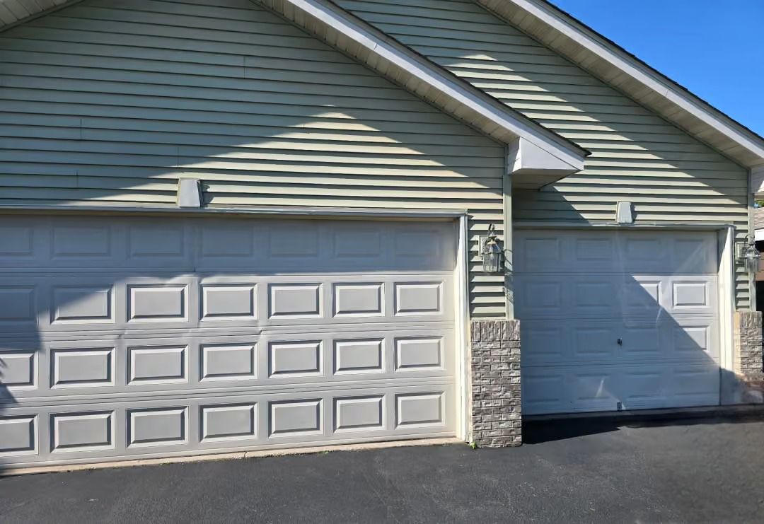 Suburban home exterior with a two-car garage and single white side garage door