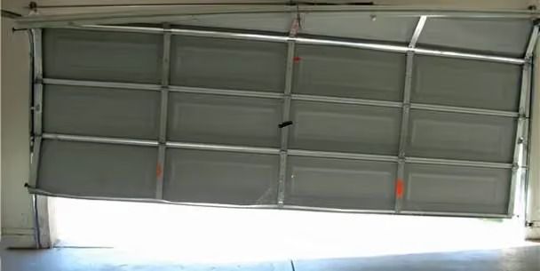 Tilted gray garage door with small windows, seen from inside
