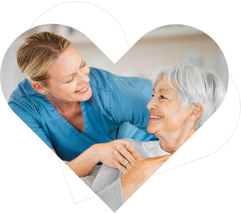 Two women smiling and embracing inside a white heart frame