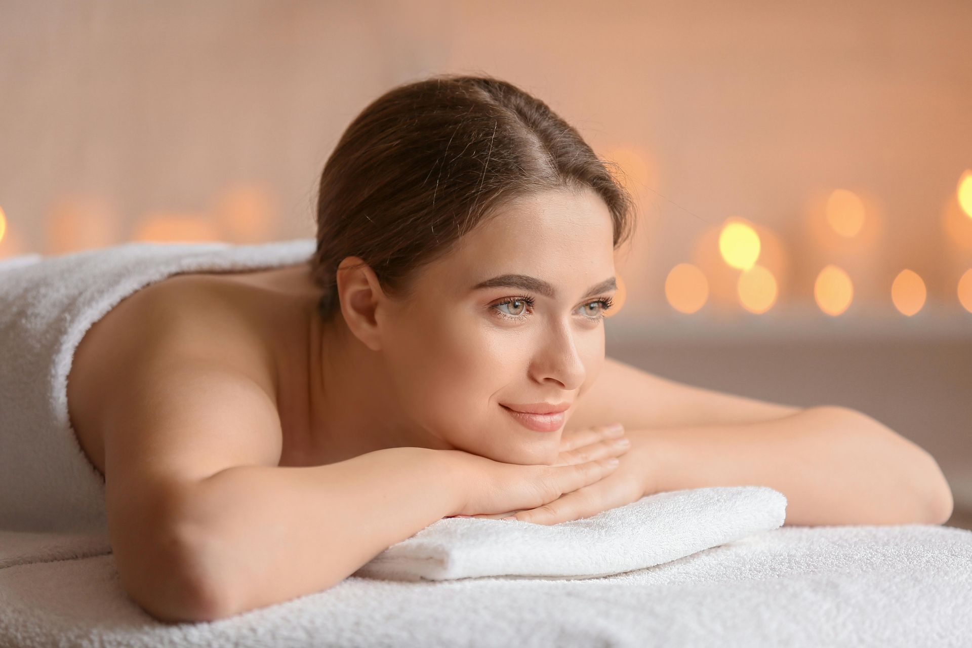 A woman is getting a hot stone massage at a spa.