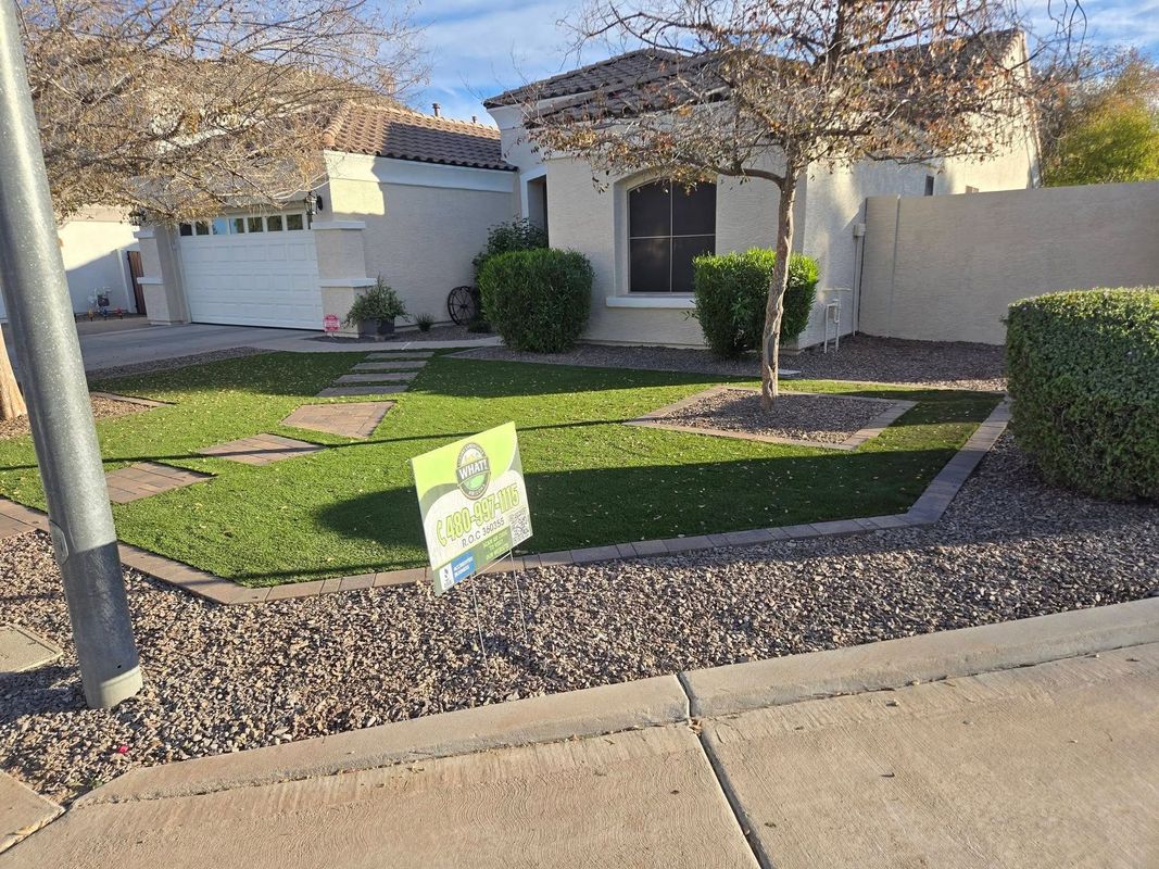 Suburban house with a front lawn and a yard sign near the sidewalk