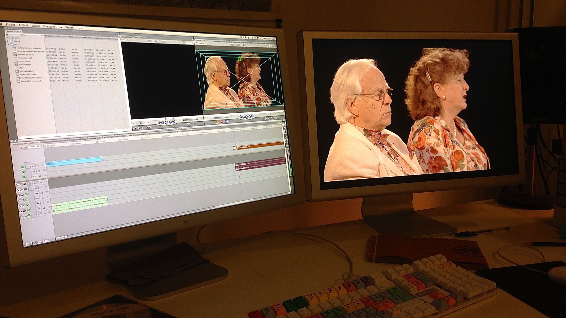Dual-monitor video editing setup showing a timeline on one screen and two people on the other.