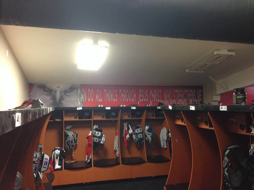A locker room with a sign on the wall that says