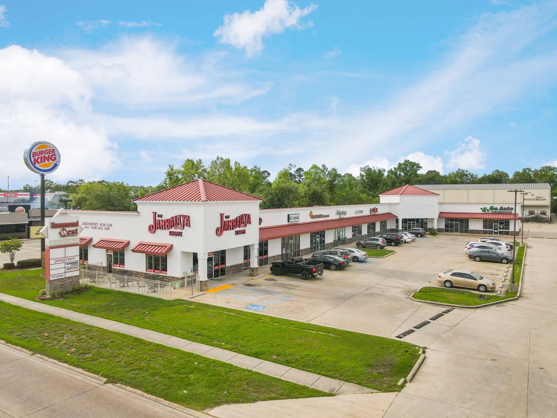 An aerial view of a burger king restaurant with cars parked in front of it.