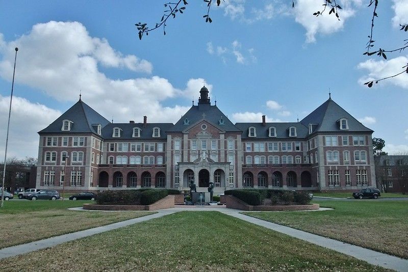 A large brick building with arches and a clock tower
