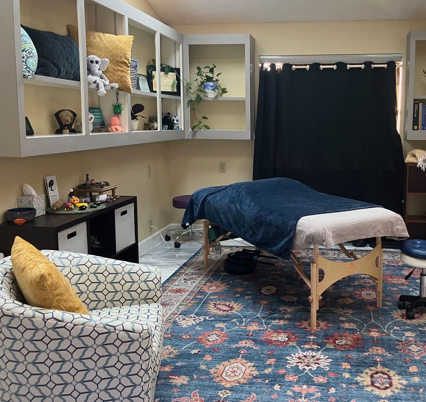 Lisa's bodywork office. massage table in a room with a picture of mountains on the wall.