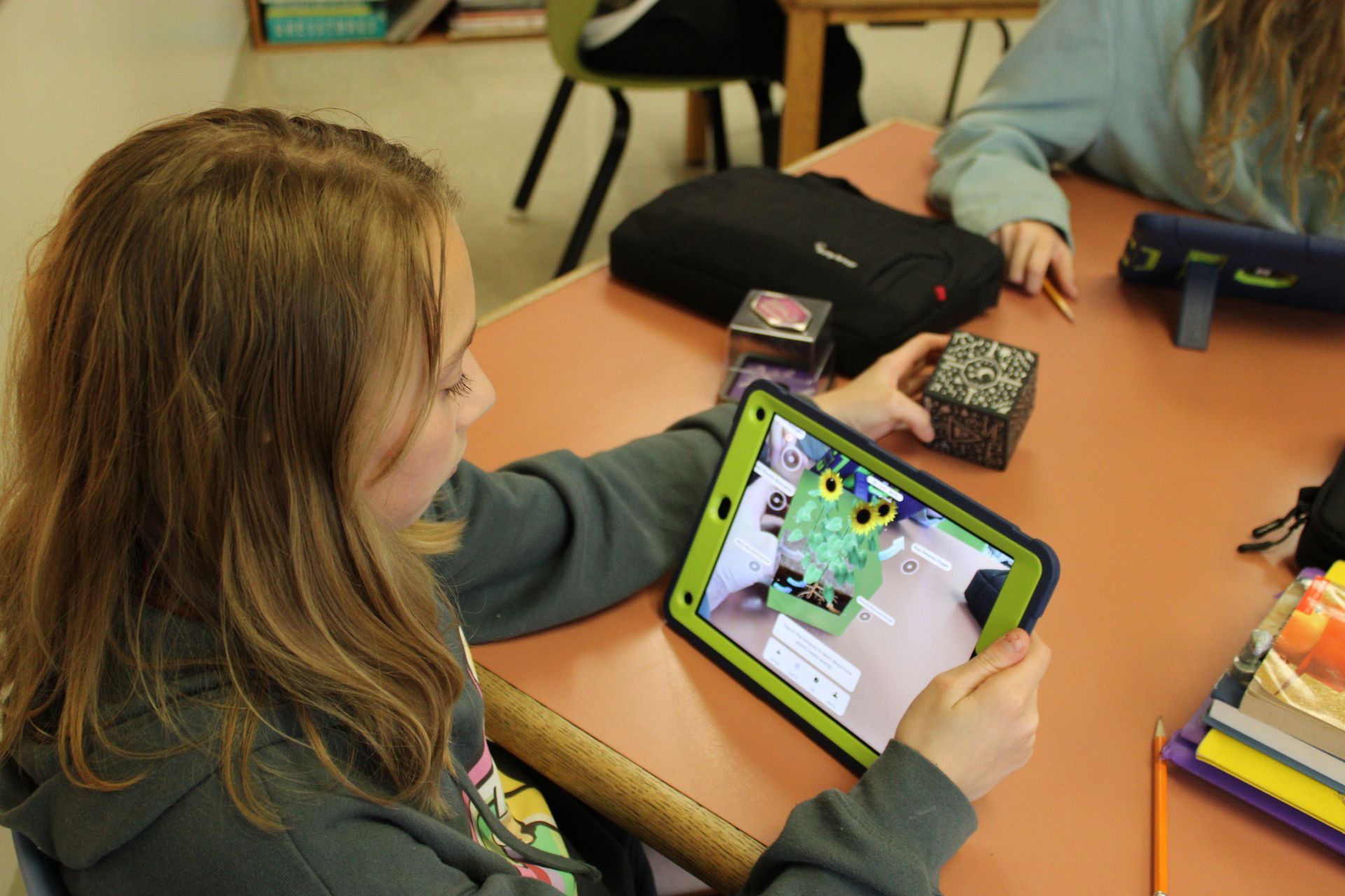 A girl is playing a game on a tablet