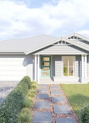 Front view of a white house with a teal front door, stone path, and small lawn under a bright sky — Twomey Homes in Delacombe, VIC
