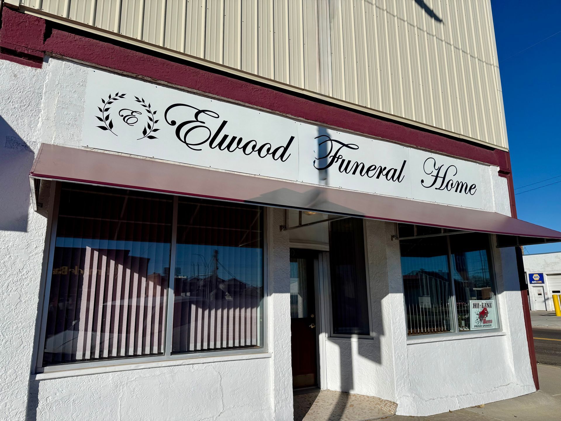 A funeral home is located on the corner of a street in a small town.