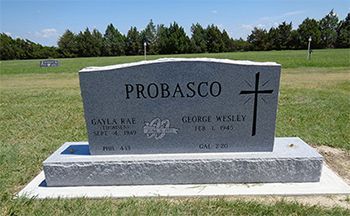 A gravestone with the name probasco and a cross on it