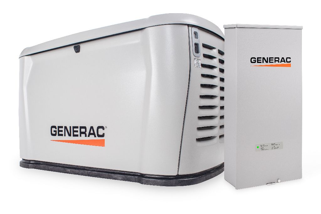A generator is sitting in the grass in front of a house