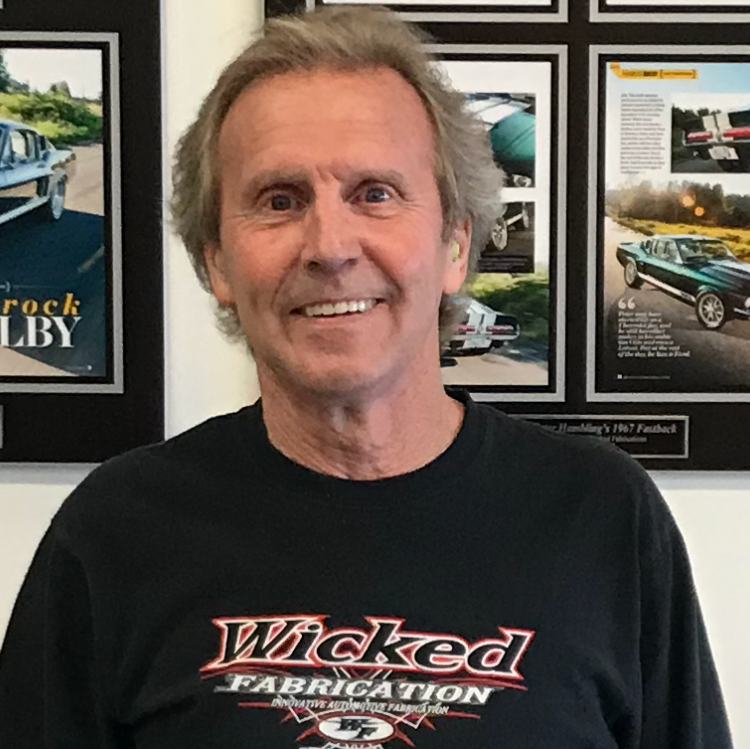A man wearing a black shirt that says wicked fabrication