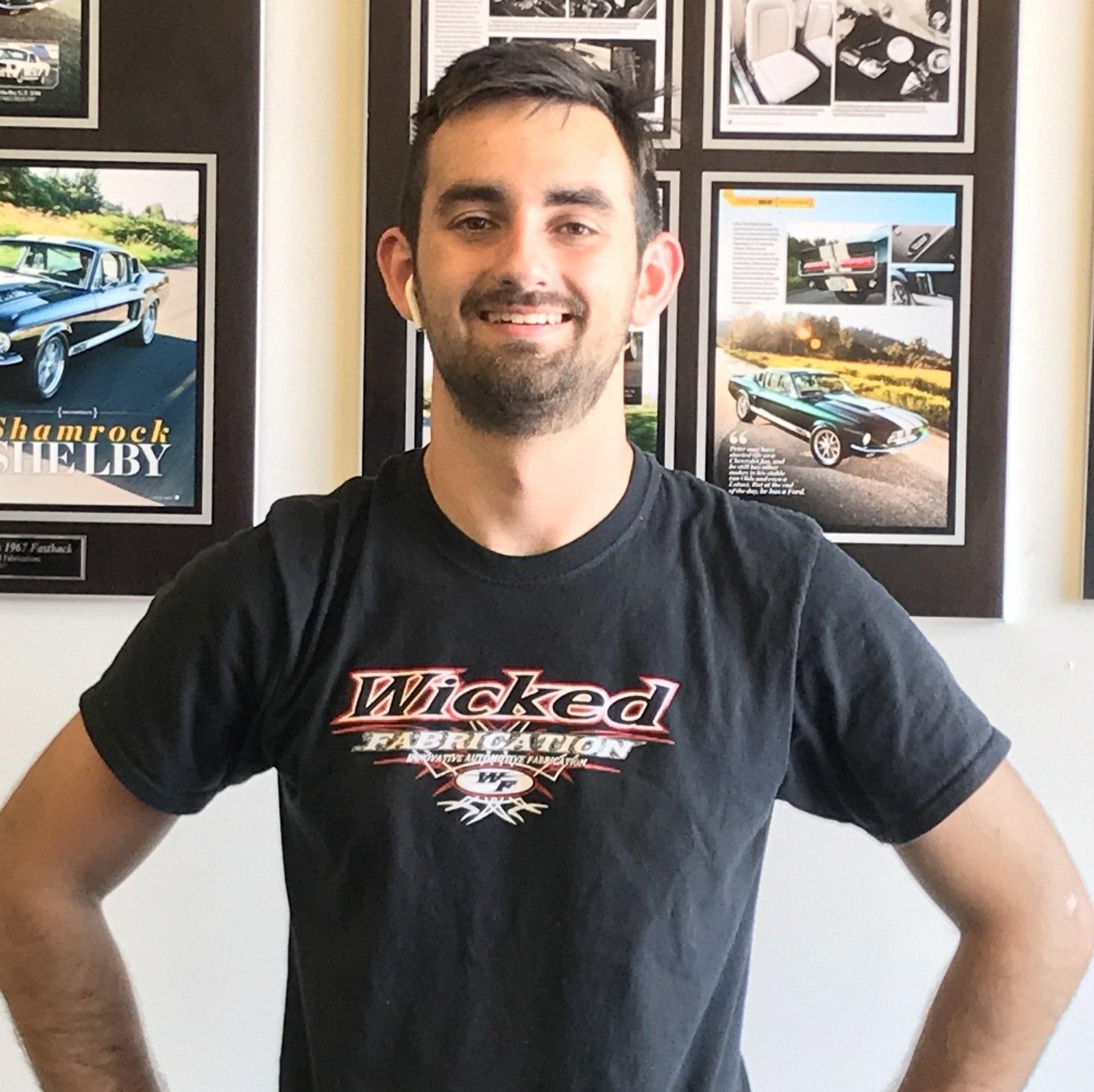 A man wearing a black shirt that says wicked fabrication