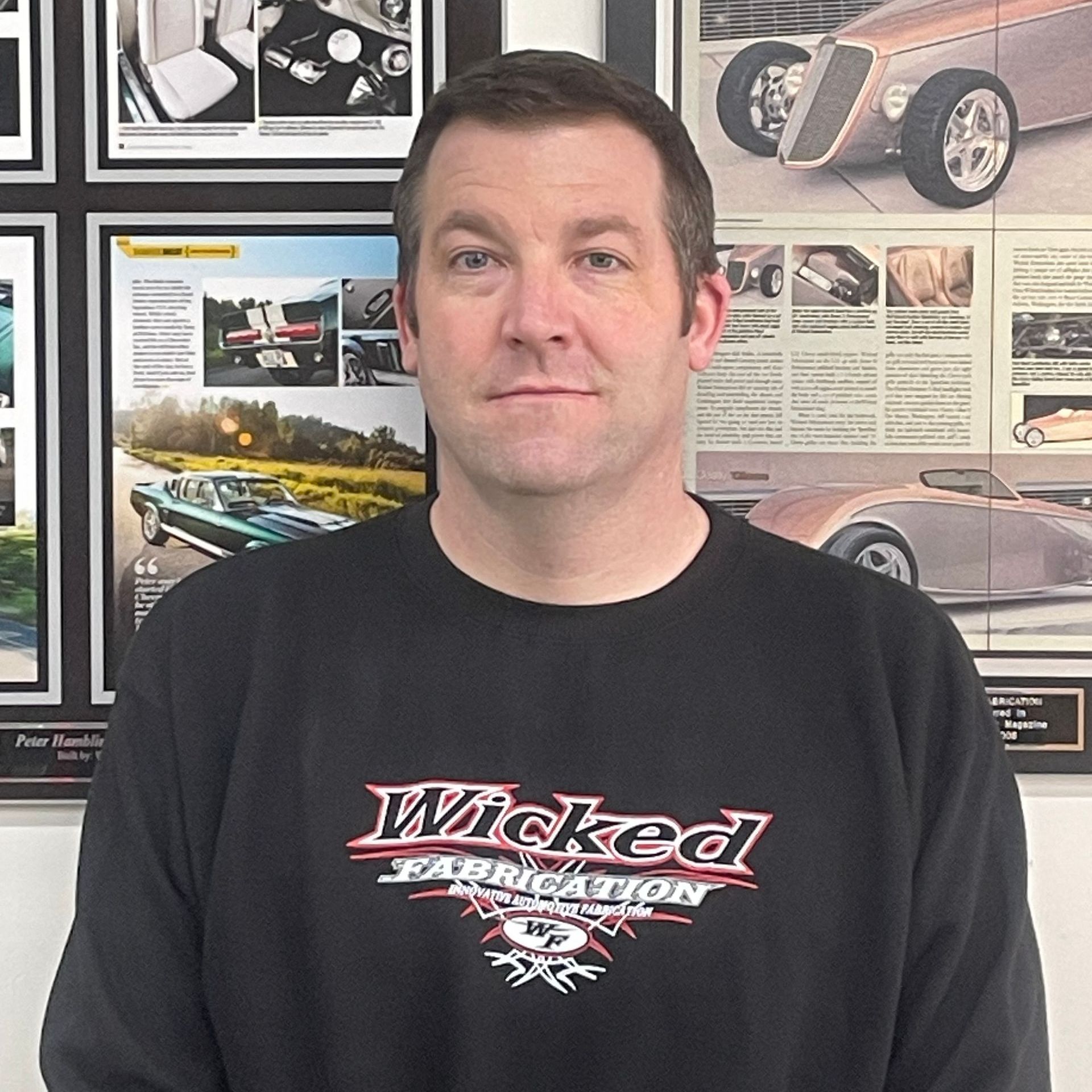 A man with a beard is wearing a wicked t-shirt