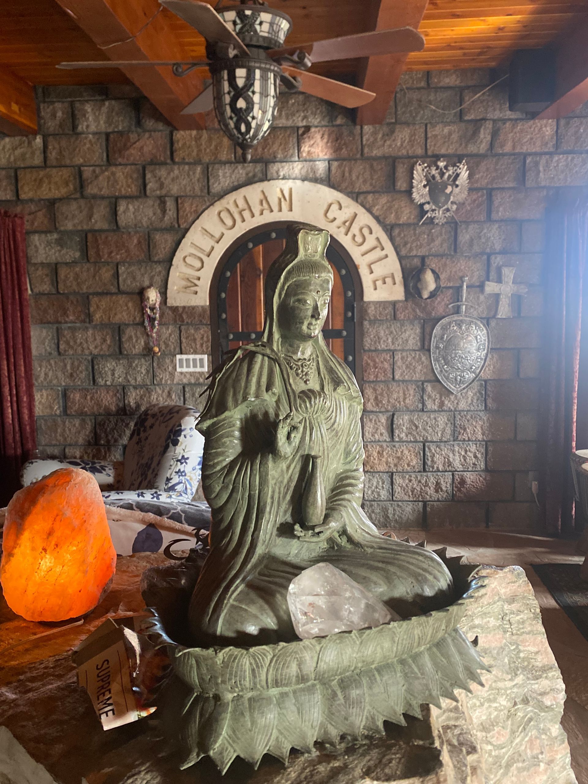 Statue of a seated figure in a castle interior, with 