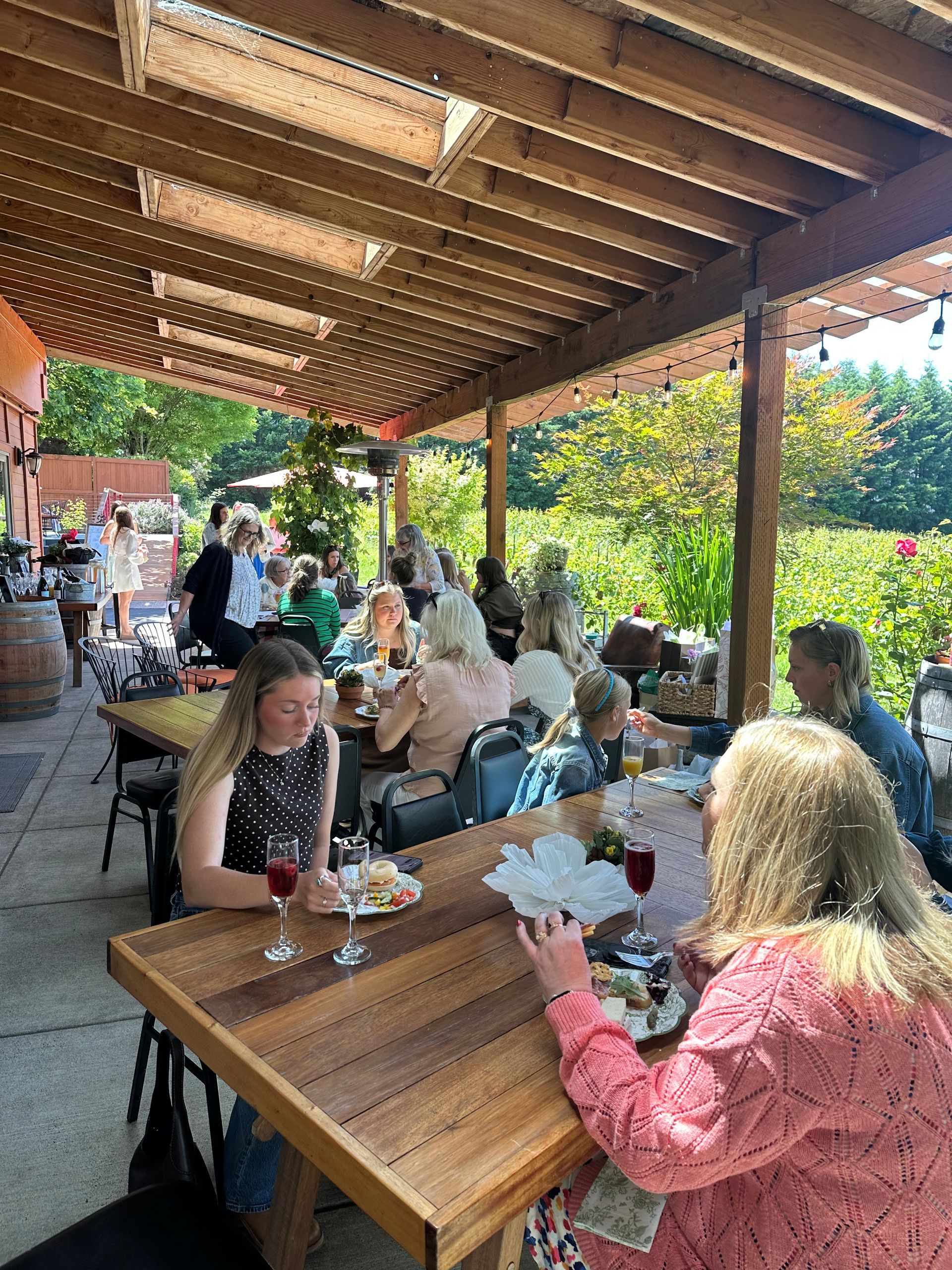 People eating and drinking wine on the back patio