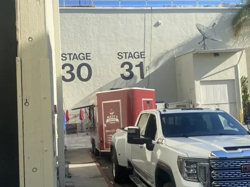 White pickup and red trailer near Stage 30 and 31 in an industrial area