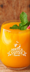 Orange juice in a glass with mint garnish and a strawberry, with a coffee logo on the front.