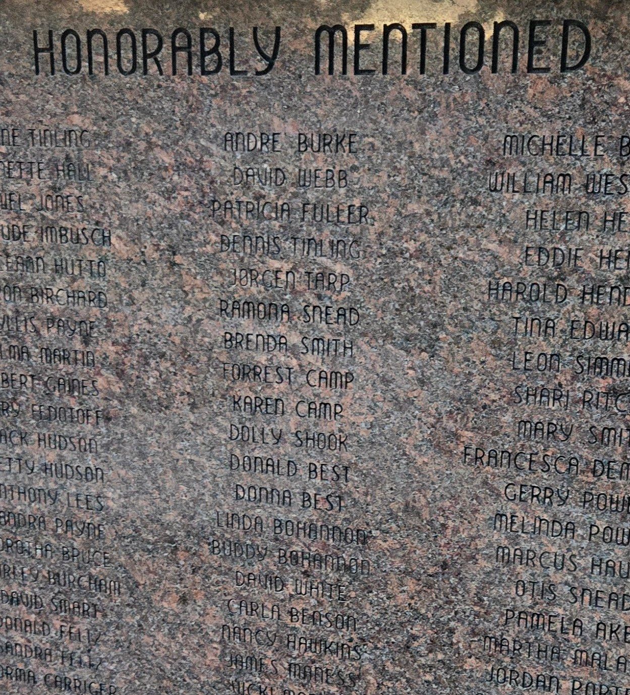 Granite memorial wall with engraved names honoring loved ones in a peaceful and lasting tribute space