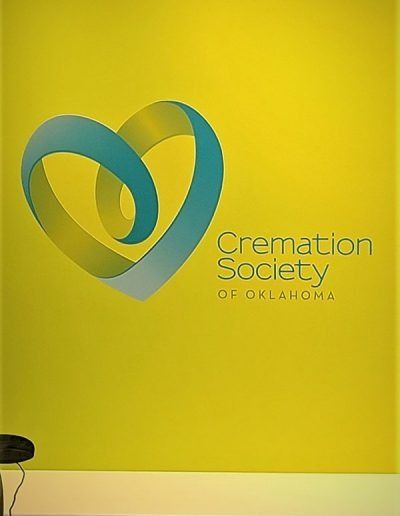 Cremation Society of Oklahoma logo on a bright yellow wall