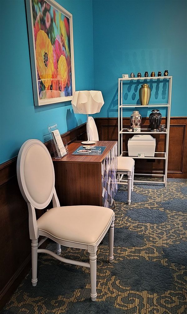 Memorial display room with urns, seating, and decor offering a peaceful space for reflection and remembrance