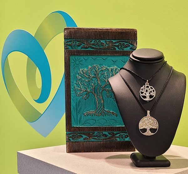 Tree of Life memorial necklaces displayed with a decorative keepsake box representing lasting remembrance