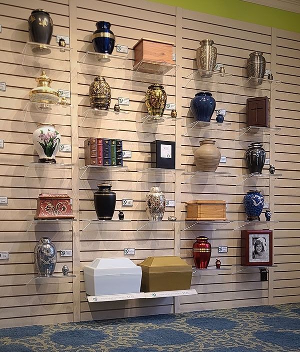 Memorial display wall featuring urns and keepsakes, providing families with personalized tribute options