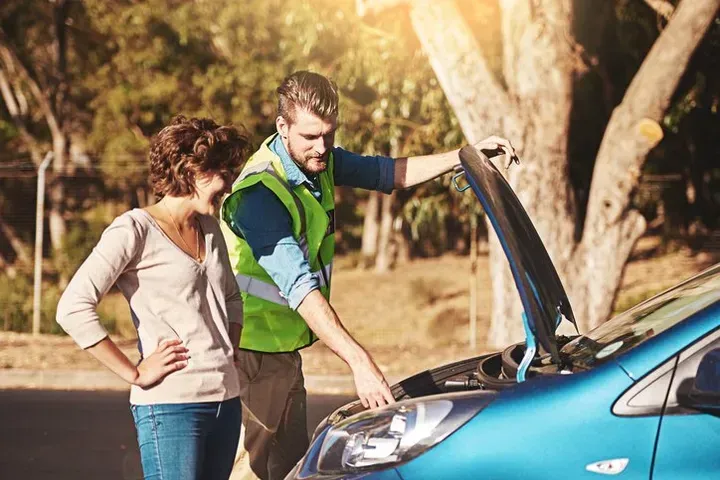Man Repairing The Woman's Car Man Repairing The Woman's Car