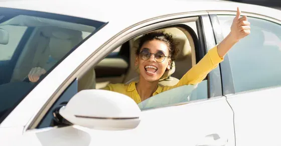 A Happy Woman Riding a Car