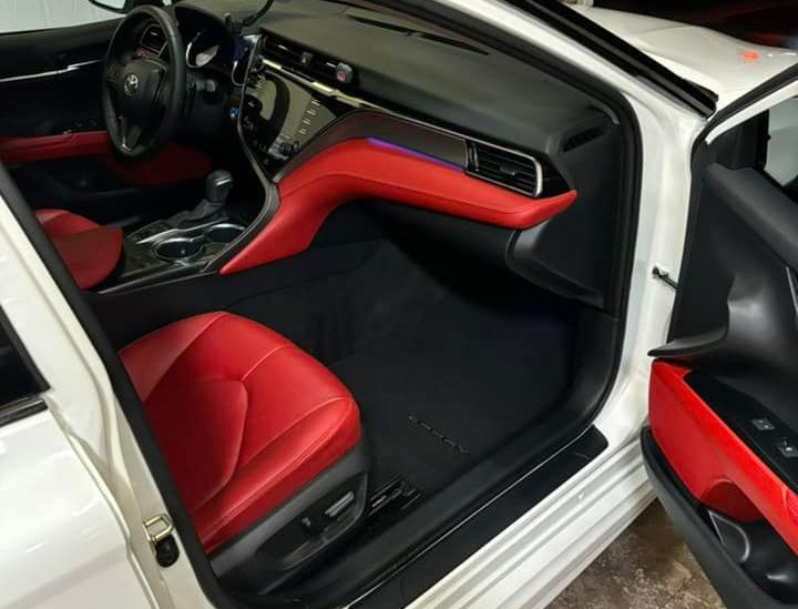 The inside of a white car with red seats