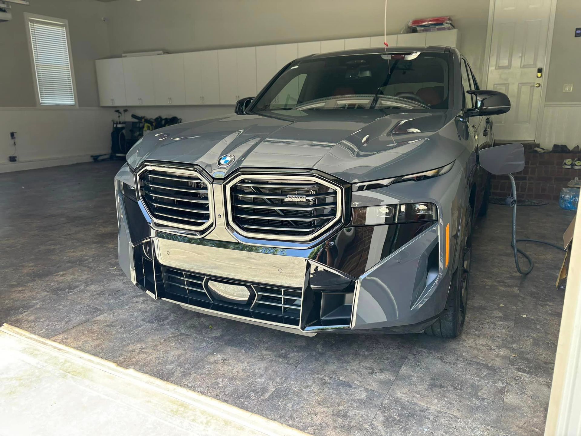 A bmw x5 is parked in a garage.
