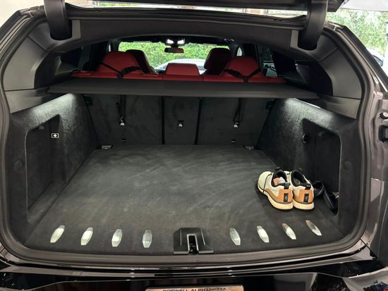 The trunk of a car with a pair of shoes in it