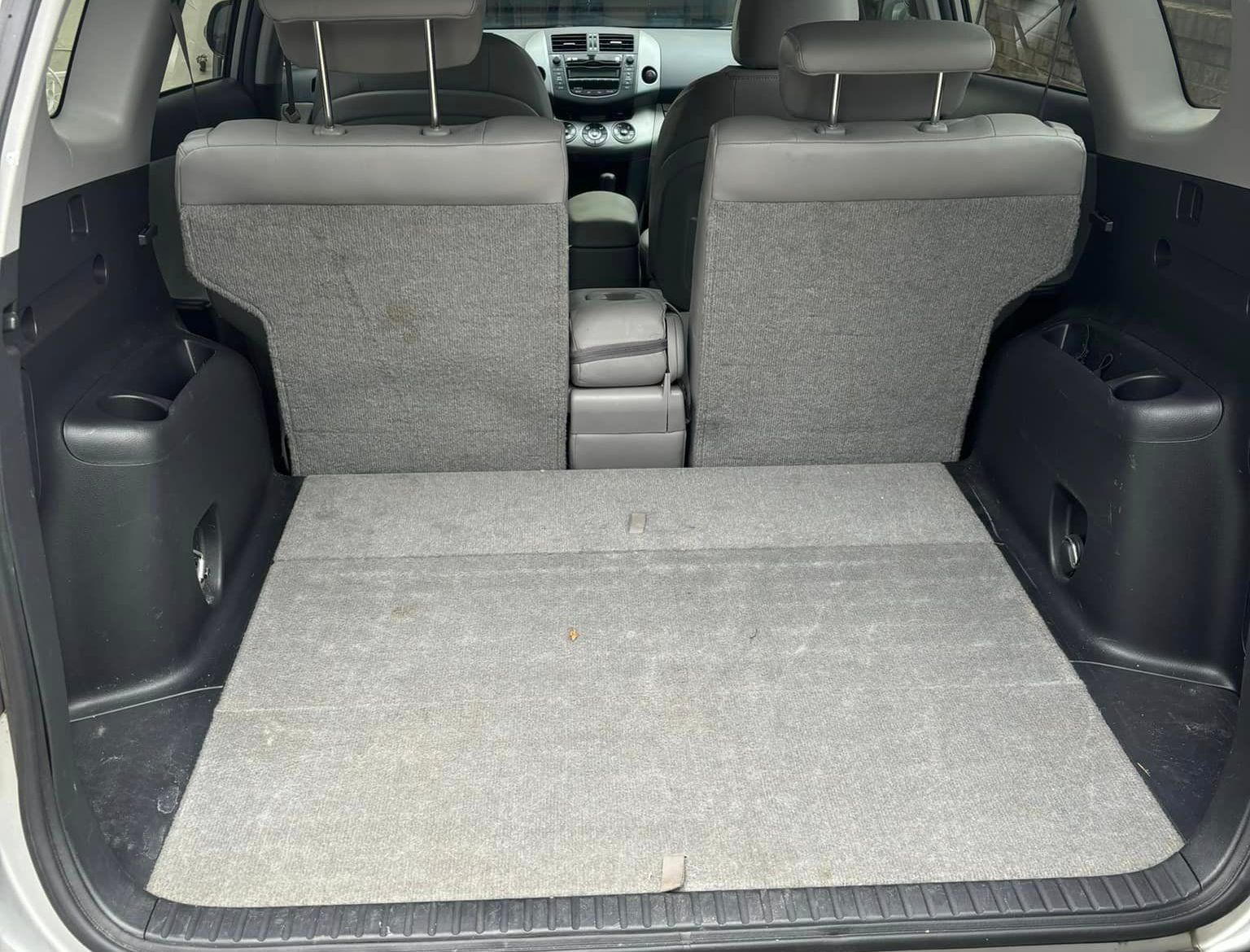 The back of a car with the trunk open and the seats folded down.