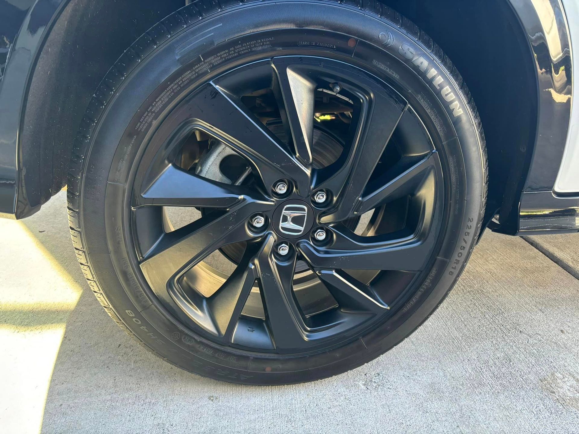 A close up of a car wheel with a honda logo on it